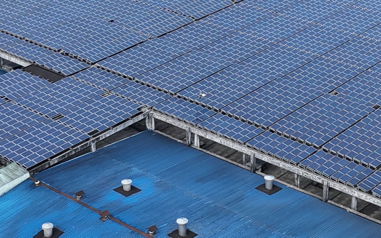 Generic industrial rooftop covered with photovoltaic panels